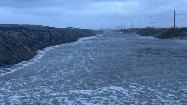 4 feet of water and deep sand submerge Highway 12 on Pea Island