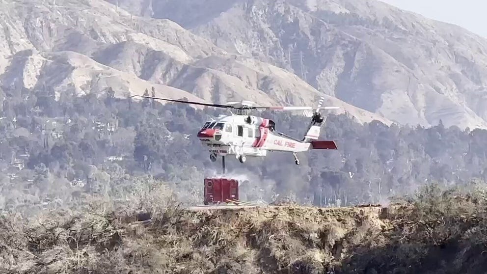 A helicopter picks up water to fight Los Angeles area fires in January 2025 near the "JPL Mesa," the JPL emergency helicopter landing facility.