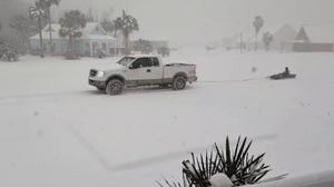 Louisianans drag kayak behind truck in historic winter storm