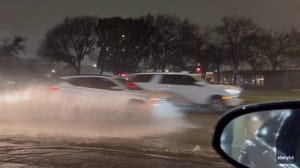 Watch: Cars drive over flooded roadway in Dallas-Fort Worth area