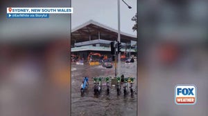 Watch: Trash can floats down flooded Sydney street amid intense rainfall