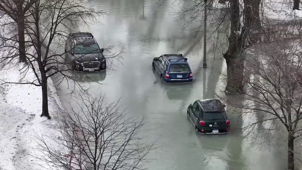 Drone video shot on Friday shows a large water main break inundating a snow-laden neighborhood in Skokie, Illinois.