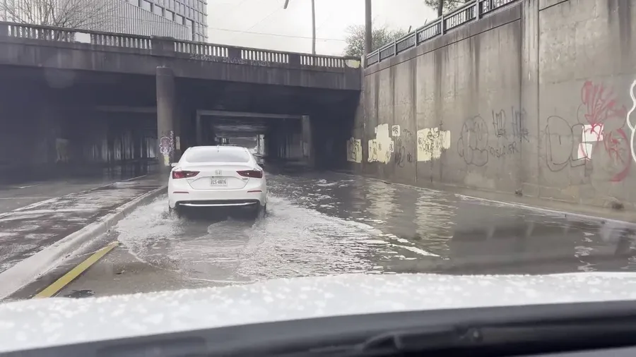 Cars drive through flooded streets in Atlanta