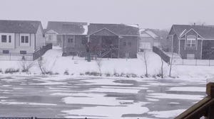 Blowing snow reduces visibility in Wichita, Kansas, as winter storm moves in 