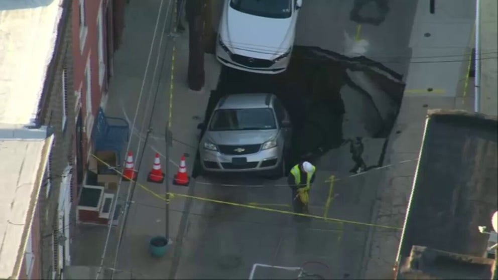 A sinkhole has shut down a street in downtown Philadelphia as one car has already fallen through. (Video courtesy: FOX 29 Philadelphia / KYW-TV) 