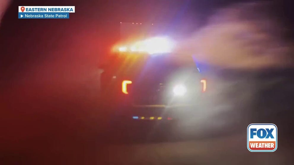 Police warned residents in eastern Nebraska against travelling on Tuesday as a blizzard whipped through the area, creating hazardous conditions. Footage from the Nebraska State Patrol shows a police car with flashing lights obscured by blowing snow.