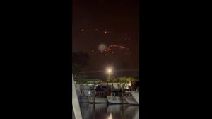 Onlookers from the Turks and Caicos Islands observe the fiery scene of the SpaceX debris falling from the sky.