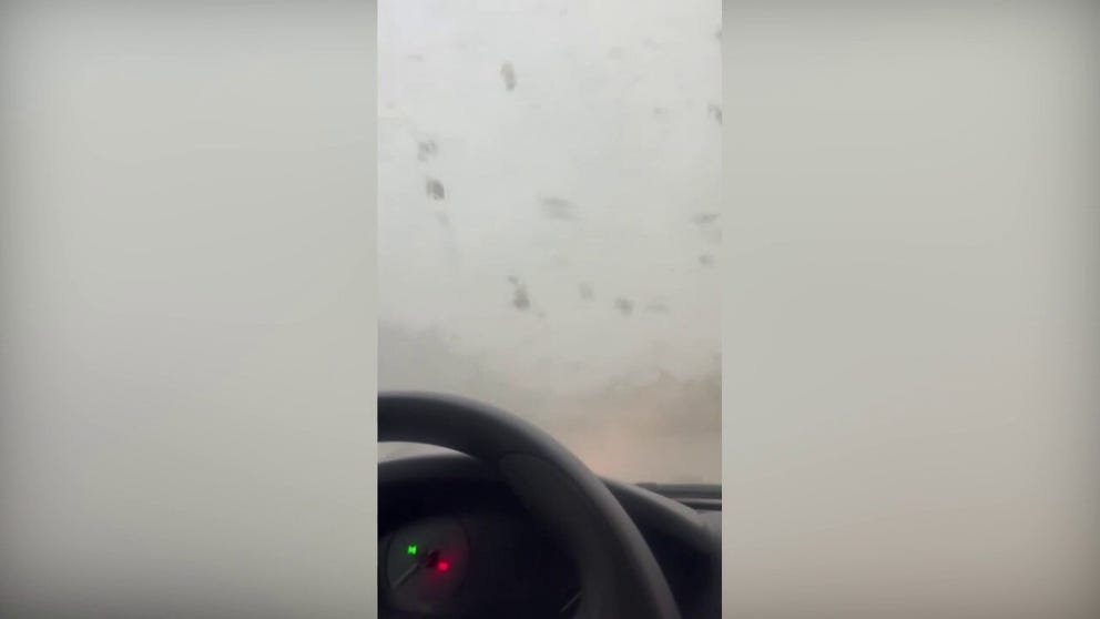 A video shot in Longwood, Florida, shows a tornado hurling debris toward a woman as she was trapped in her car during the storm on Monday. (Courtesy: Jeanicmar Rangel / TMX)