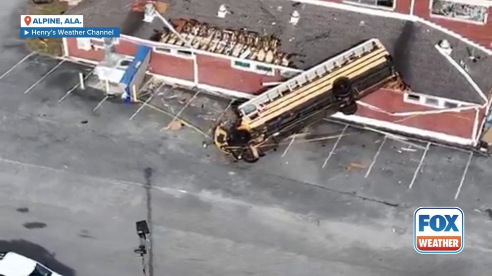 Drone video shows how 120 mph winds from an EF-2 tornado near Winterboro, Alabama flipped a school bus onto the high school gym.