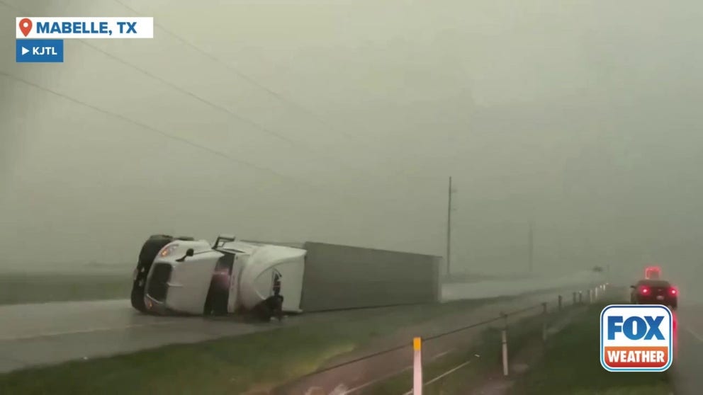 A tractor-trailer toppled amid raging wind and rain Tuesday night near Mabelle, Texas (Video Credit: KJTL).