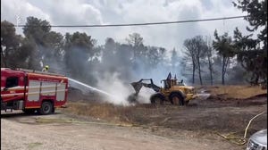 Firefighters work to contain raging wildfires in Israel