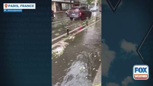 Cars drive through flooded streets in Paris