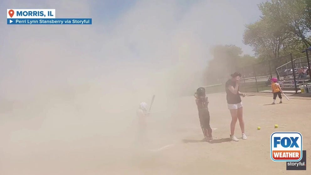 Players in a Little League softball game had to briefly pause their game as a dust devil spun through the middle of the field. Video captured the moment players and coaches covered their eyes as the dust knocked over the bats. 
