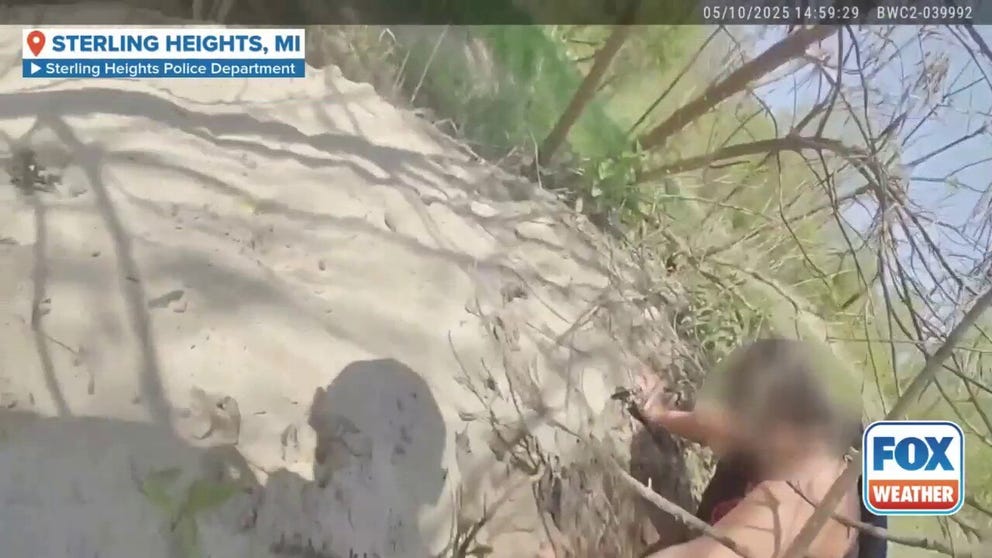 A Sterling Heights police officer who is also a Navy veteran heroically jumped into a river in Michigan to save a first-time kayaker who was clinging to a log after her kayak overturned. Bodycam footage shows the rescue. 