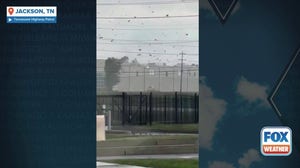Debris swirls around Jackson, Tennessee warehouse during tornado-warned storm