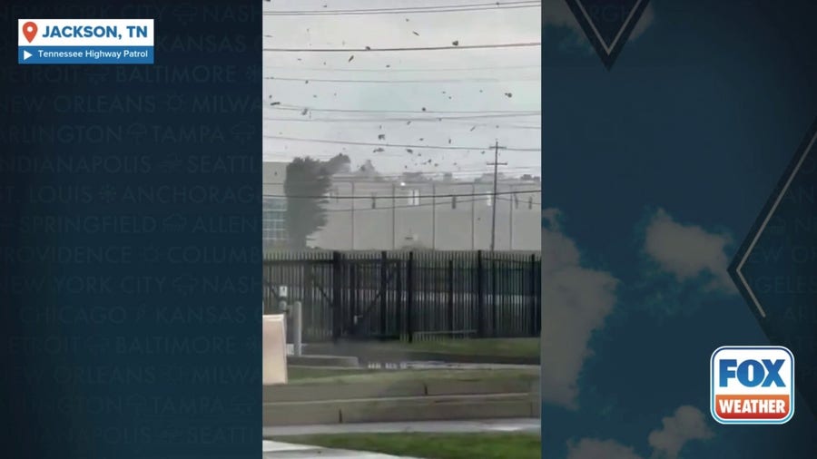 Debris swirls around Jackson, Tennessee warehouse during tornado-warned storm