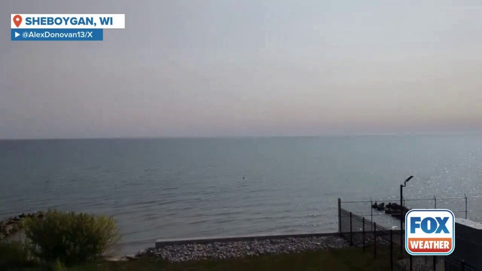 Uncontrolled wildfires in Canada continue to waft smoke into the central and eastern U.S. This smoky scene was captured near Sheboygan, Wisconsin, on Sunday. Air quality alerts are in effect to the west in Minnesota.