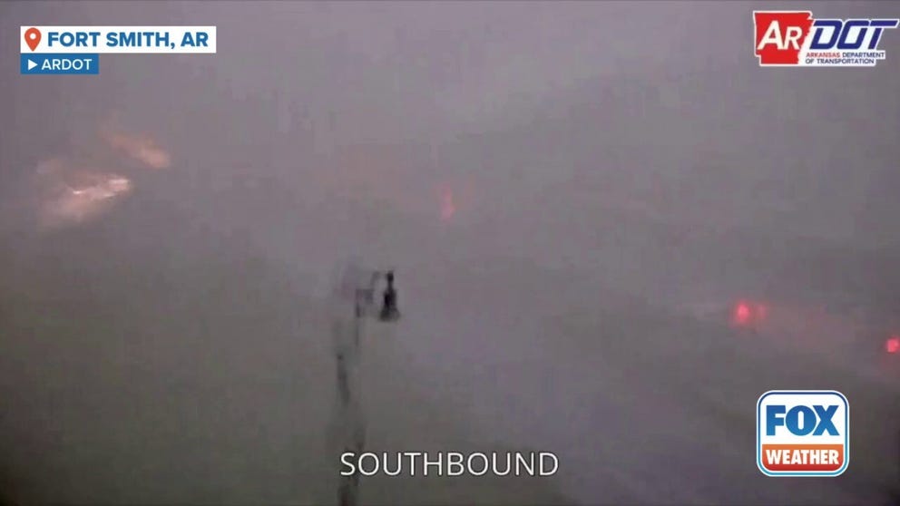 A tornado-warned storm was caught on a traffic camera as it swept through Fort Smith, AR on Friday morning. 