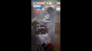Strong rain and winds whipping against the Texas state flag