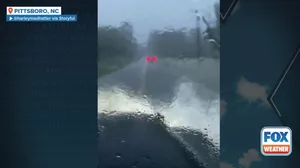 Heavy rain from the remnants of Tropical Depression Chantal flood road in central North Carolina