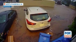 Shipping containers float through North Plainfield, New Jersey, flooding