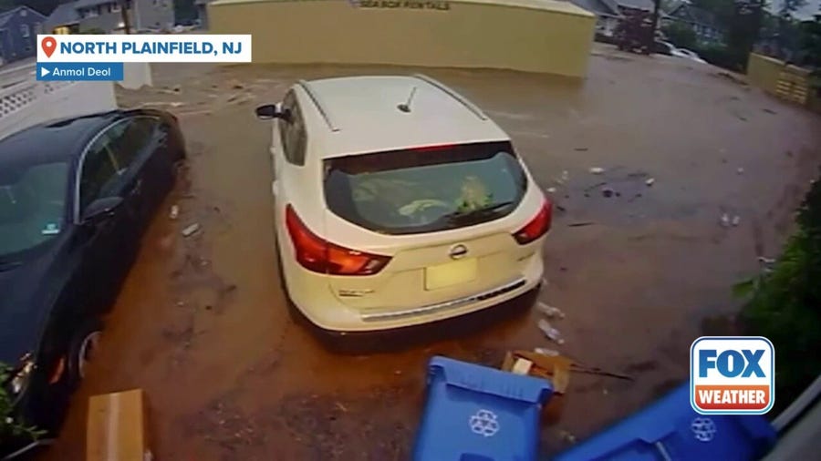 Shipping containers float through North Plainfield, New Jersey, flooding