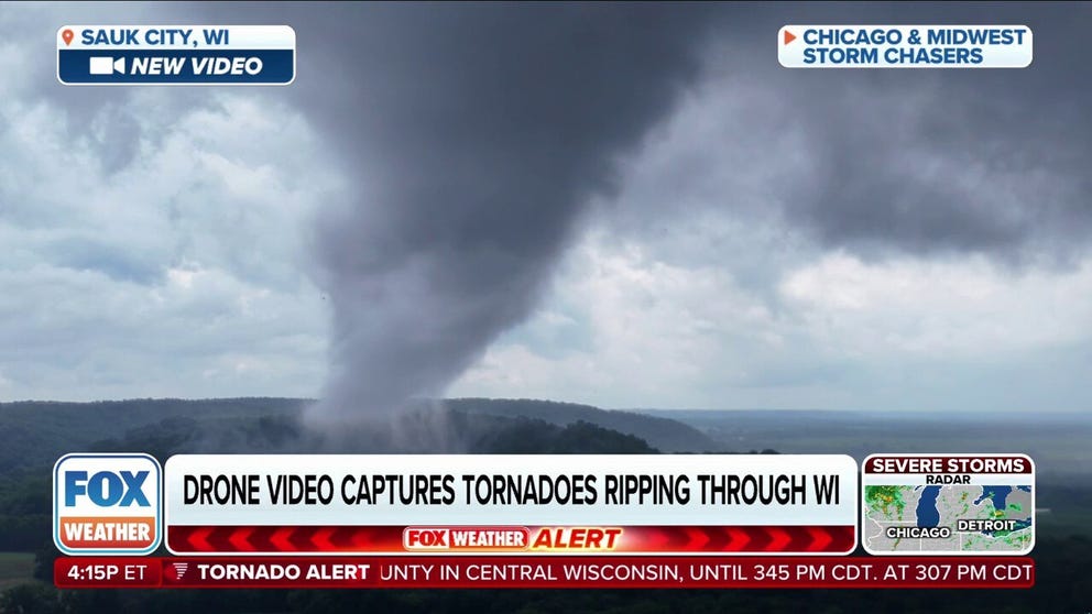 Drone video shot on Wednesday shows a tornado spinning up in Sauk City, Wisconsin.