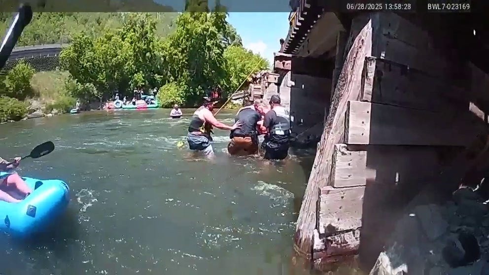 A Utah Department of Natural Resources Ranger, among several other officers and civilians jumped in to help a woman who was trapped under a trestle bridge while paddleboarding in the Provo River in Utah. 