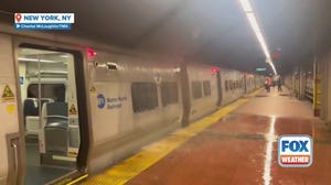 Water pours over a Metro North train in New York City's Grand Central Station during flash flood