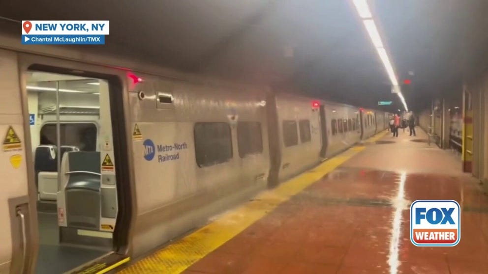 Water pours over a Metro North train in New York City's Grand Central Station amid heavy downpours that cause flash flooding throughout the city Thursday. Governor Hochul declared a State of Emergency due to the rain.