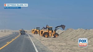 Watch: Crews build up sand dunes on Hatteras Island ahead of Hurricane Erin's impacts
