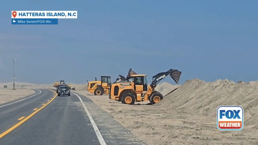 Watch: Crews build up sand dunes on Hatteras Island ahead of Hurricane Erin's impacts