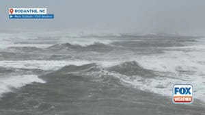 Large ocean swells produced by Hurricane Erin crash against beach in Rodanthe