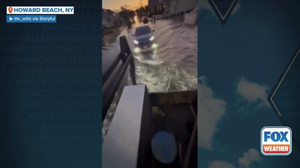 Cars drove through several inches of floodwater from Hurricane Erin in Howard Beach in Queens Thursday evening. Erin caused high surf, rip currents and coastal flooding along the East Coast, 