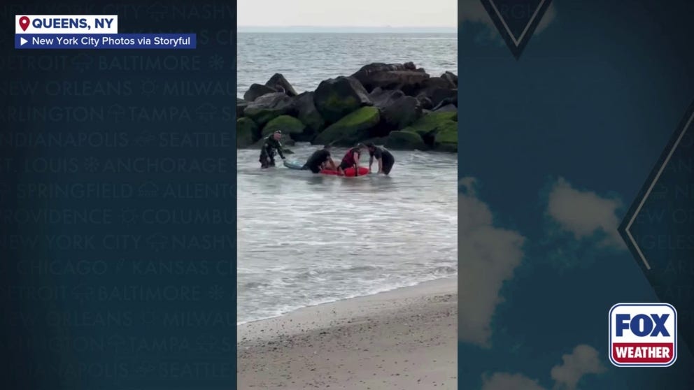 New York City firefighters rescued two swimmers who became caught in a rip current.