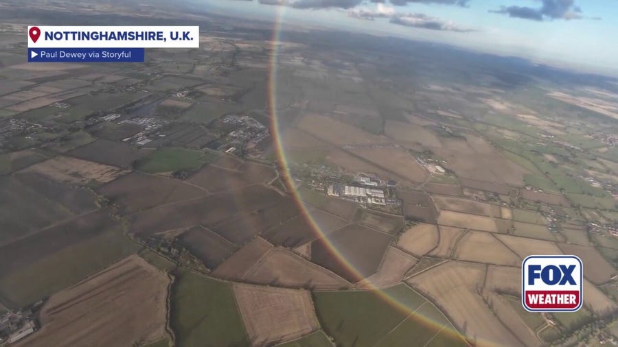 Skydivers capture beautiful full rainbow moment