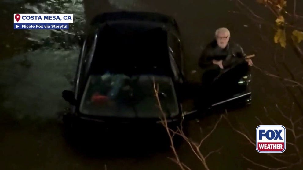 Costa Mesa roommates save a Vietnam War veteran after they saw his car floating and spinning in floodwaters, called 911 and ran down to help him.