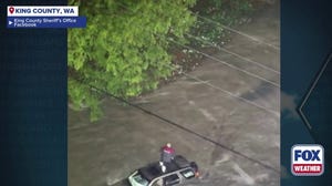 Watch: First responders rescue Washington man from roof of SUV, amid historic flooding