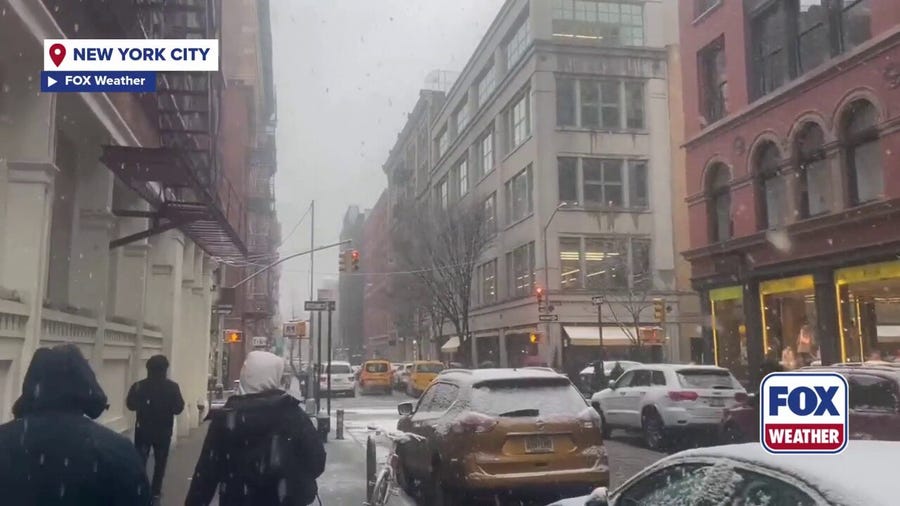 New Yorkers trudge through snowy conditions in SoHo
