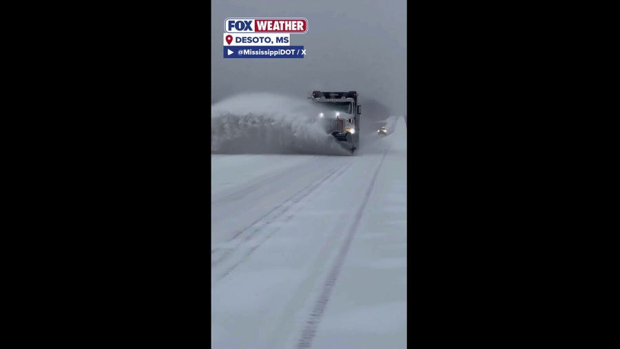 Mississippi Department of Transportation crews clear heavy snow