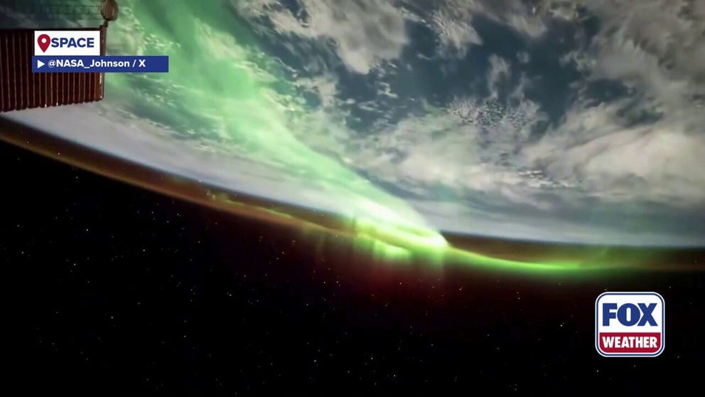 Footage released by NASA on Wednesday reveals aurora ribbons shimmering above Earth, while a thin orange line of the atmosphere highlights the planet’s edge.