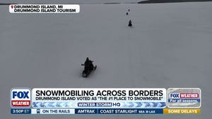 Natural ice bridge draws snowmobilers to Drummond Island in Michigan