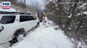 Watch: San Bernardino Fire Department rescues man and dog stranded in feet of snow