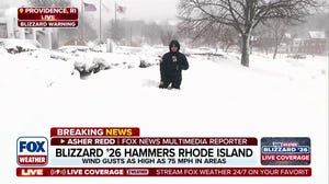 Car stuck in snow as blizzard hammers Rhode Island and sets new record