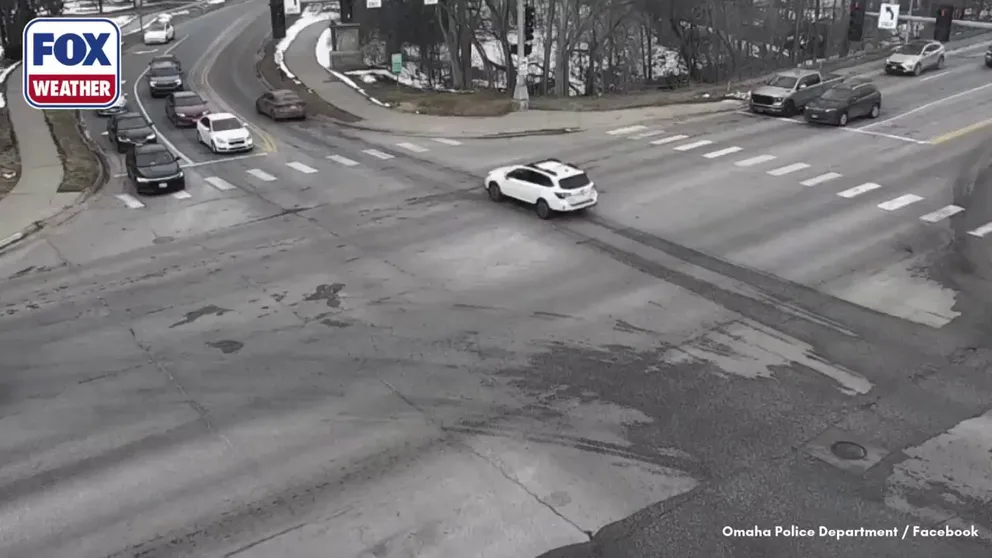 ANOTHER LOOK 👀: A security camera captured the moment two cars waiting at an intersection in Omaha, Nebraska, were partially swallowed by a sinkhole that opened up in the road.