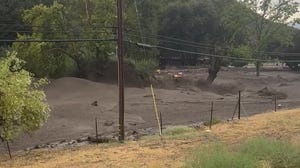 Wall of mud rolls through California town during flash flood