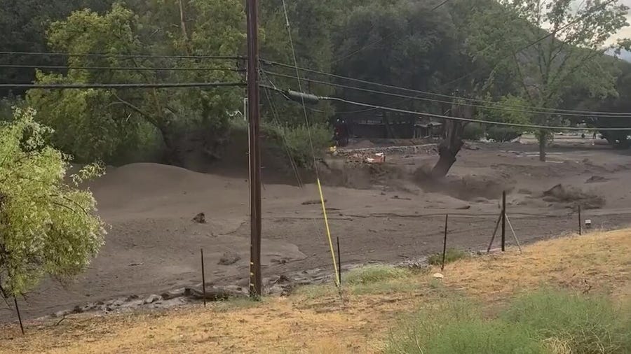 Wall of mud rolls through California town during flash flood