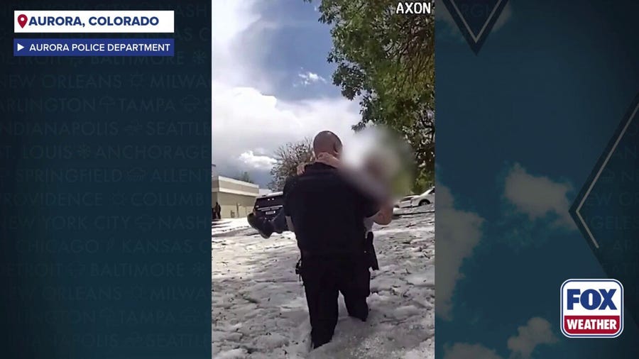Watch: Aurora police carry stranded commuter from hail-covered Colorado floodwaters
