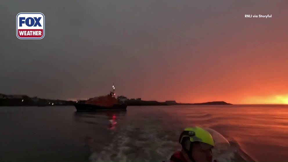 Volunteers with the Royal National Lifeboat Institution (RNLI) rescued a paddle boarder and a dog from the base of a cliff as a storm swept through Cemaes Bay, Wales, on May 27. The volunteers 