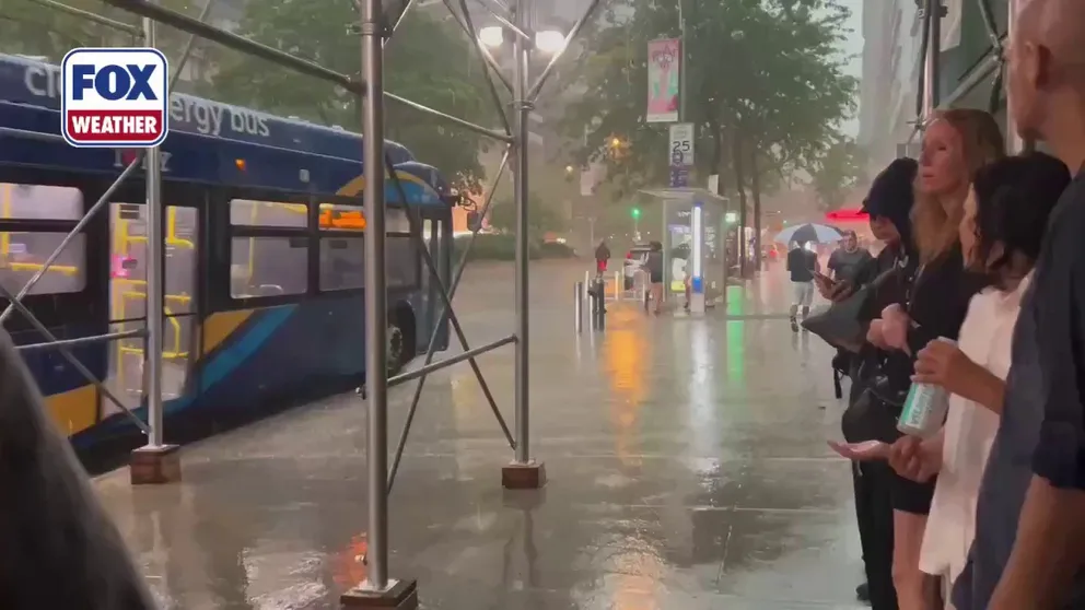 New York City was in the bullseye of severe thunderstorms Friday as several people waiting under a bus shelter made a run for their ride amid cracking thunder and sky-illuminating lightning.